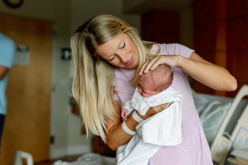 mom helping newborn during fresh 48 newborn session