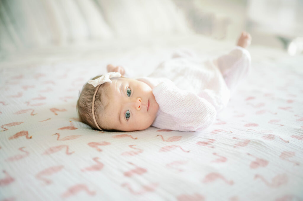 newborn laying on bed