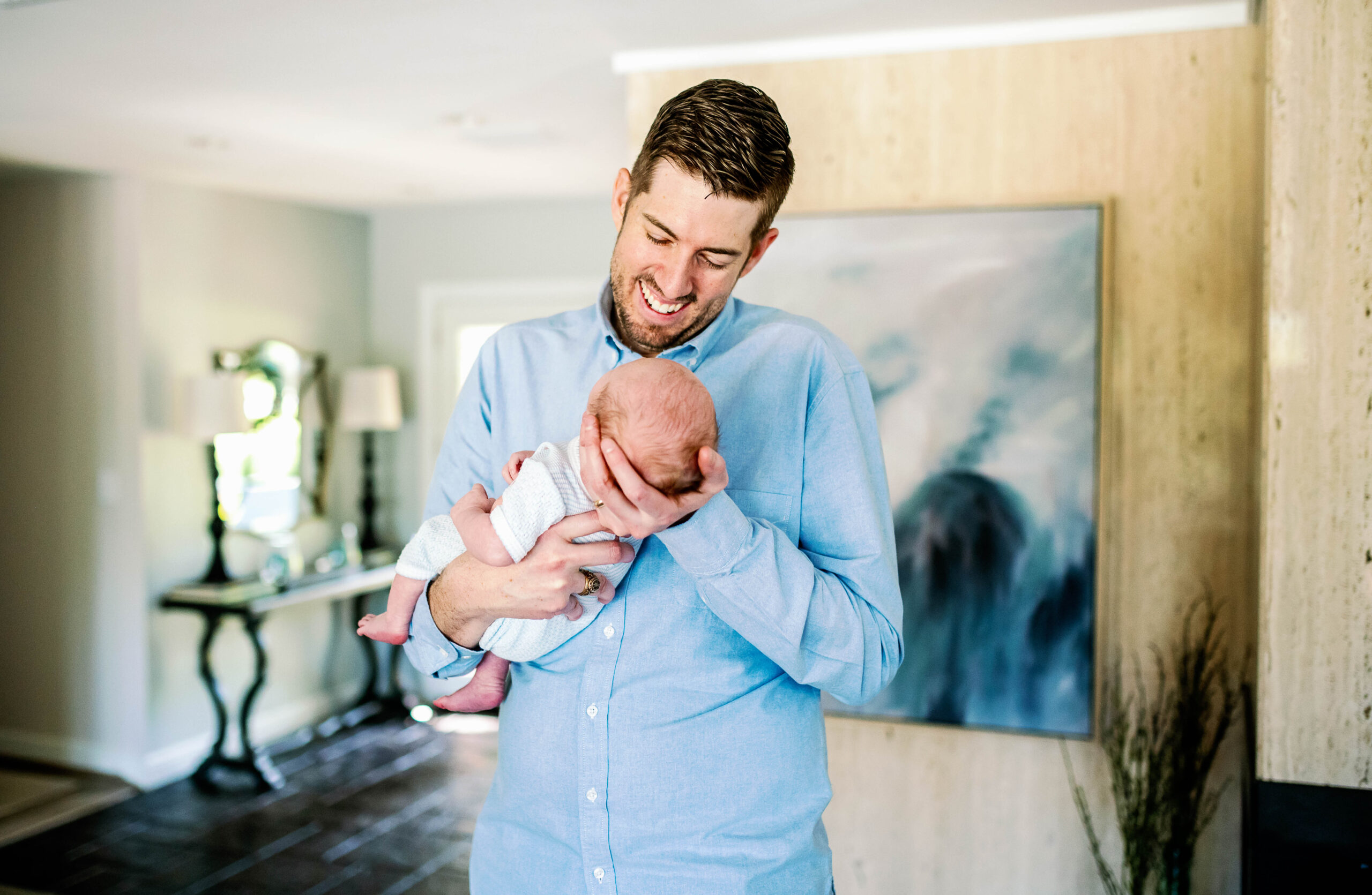 dad holding newborn during photo session