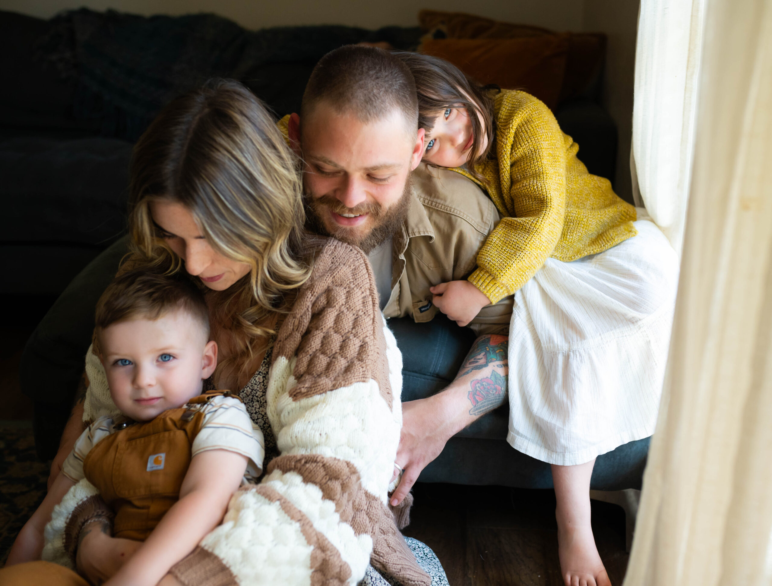 family snuggled together for photograph