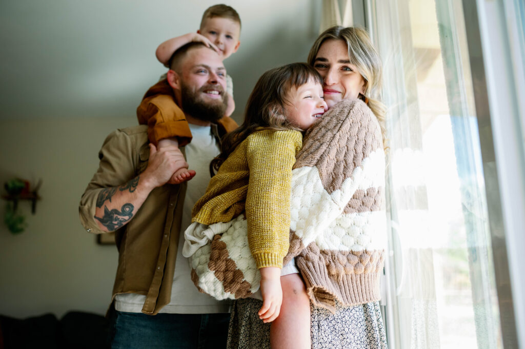 mom and dad holding children
