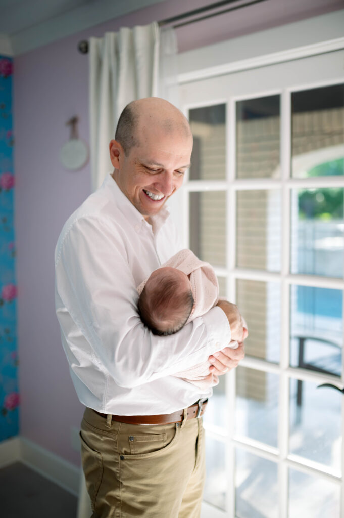 dad holding newborn daughter