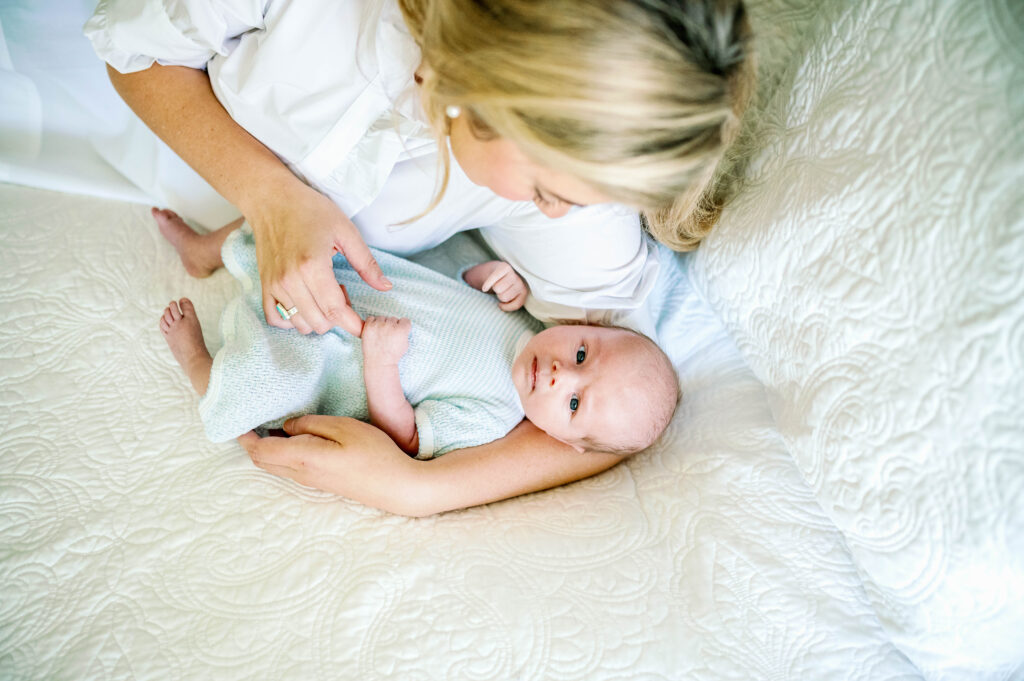 mom cradling newborn for photograph