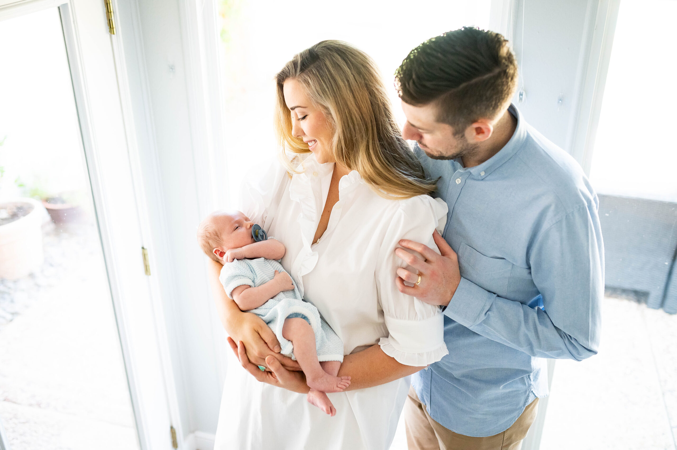 mom and dad holding newborn