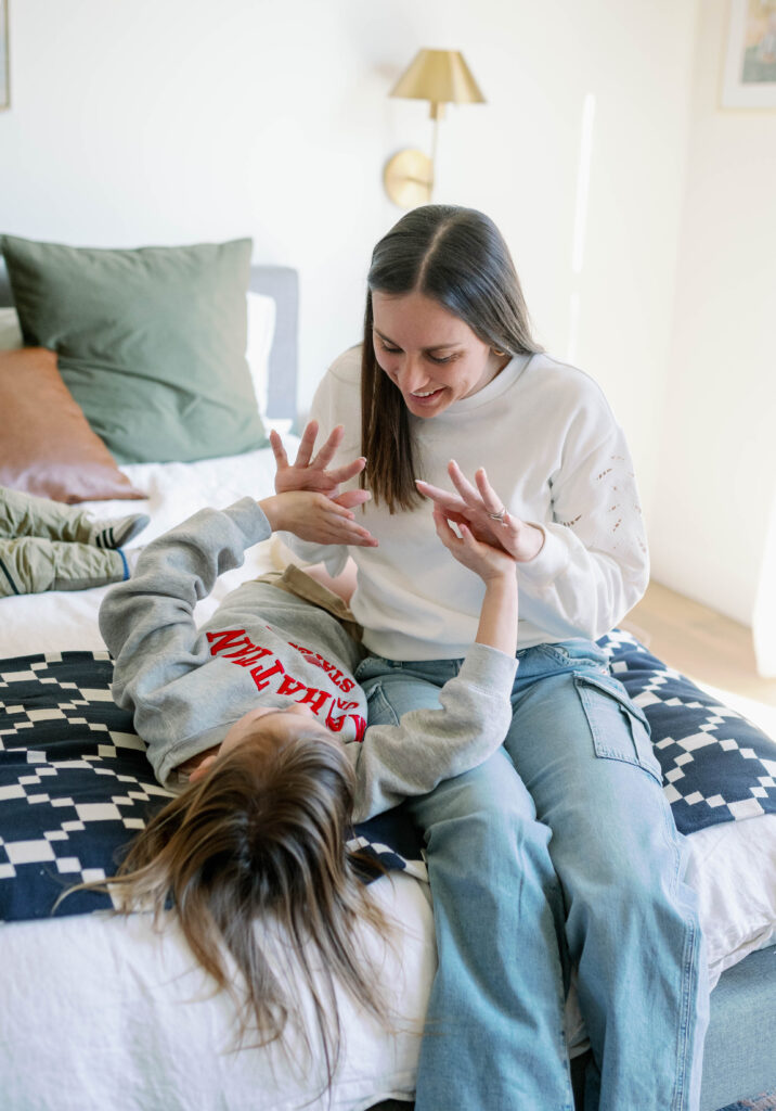 mom and daughter playing with hands