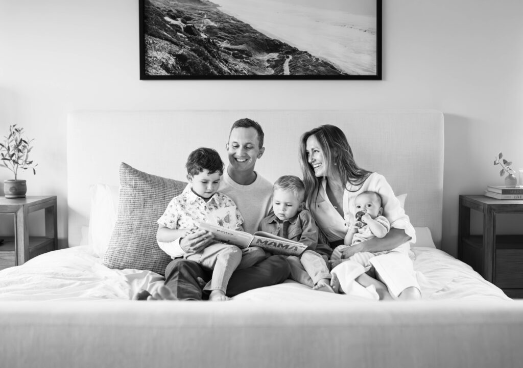 family reading togther during dallas newborn in home session
