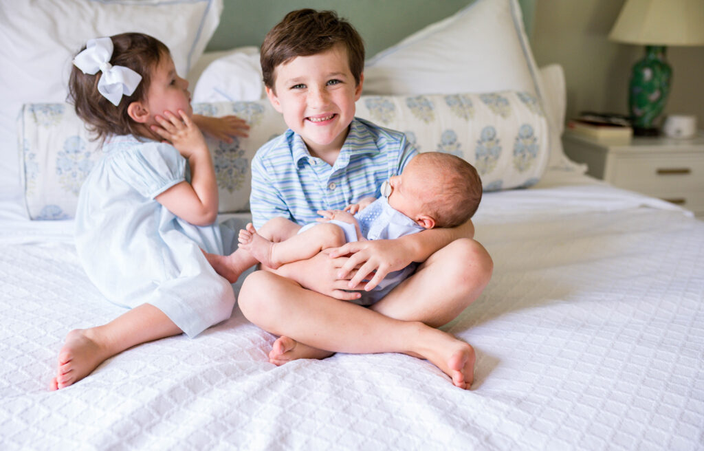 older brother holding newborn baby in DFW
 photo session
