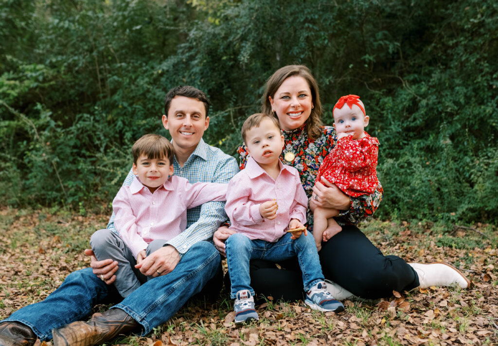 family sitting in wooded area for fort worth family mini session