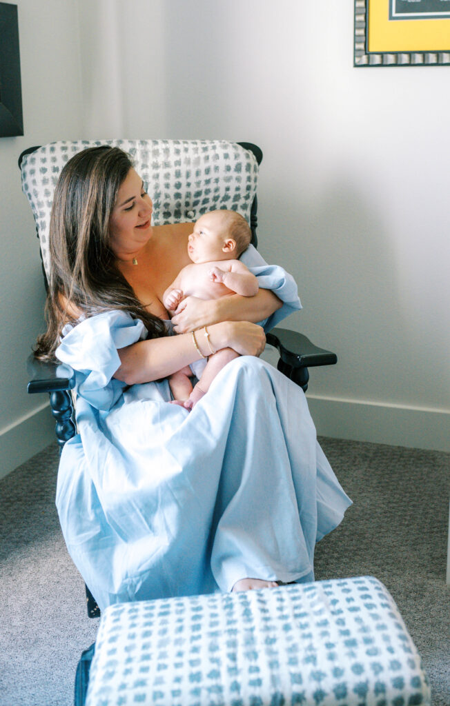 Aledo newborn photographer Allison Krogness captures mom and baby rocking together in the nursery.
