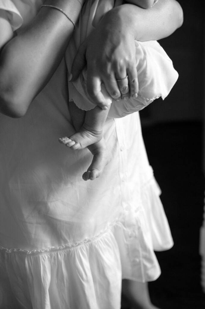 A black and white close-up of a newborn girl's feet.

