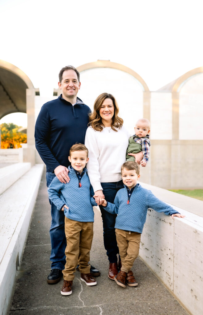 Fort Worth family of five standing in front of
 the Kimbell Art Museum for a fall mini session.