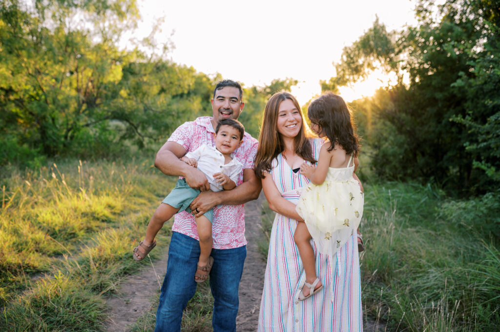 Fort Worth family playing in a field at sunset during photo session with Allison Krogness.