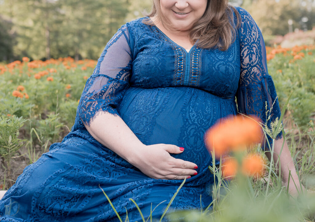 Natural outdoor maternity photos showing a mom resting her hand on her pregnant belly by Fort Worth maternity photographer Allison Krogness.

