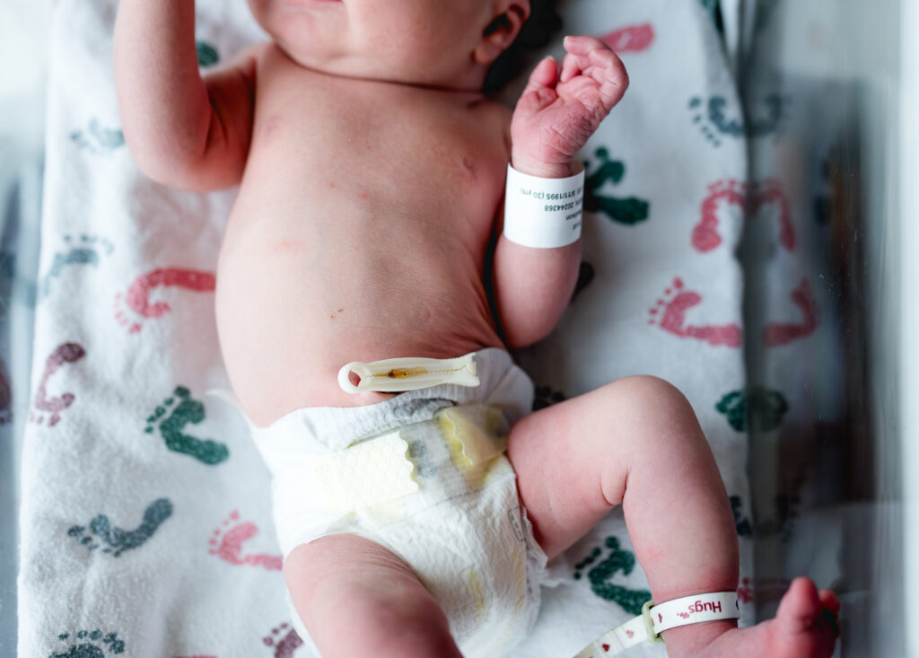 Fort Worth fresh 48 newborn photographer captures newborn tummy details at Baylor Scott & White Medical Center, Fort Worth — soft window light.
