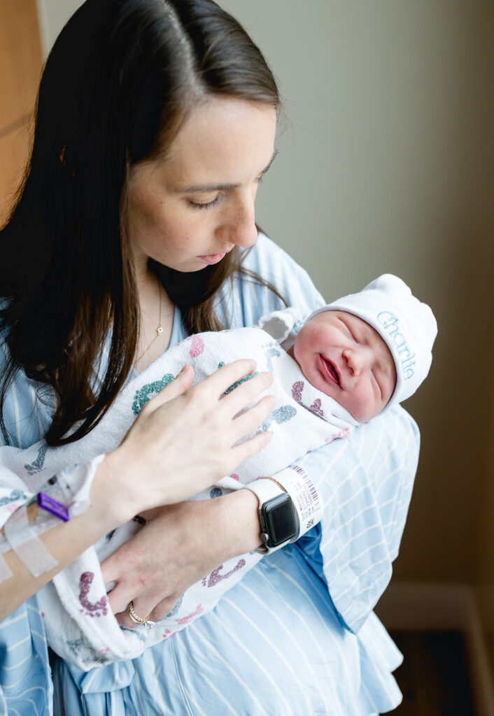 Mom in soft pajamas during Fresh 48 newborn session at Fort Worth hospital.
