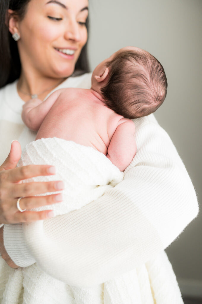 Some Fort Worth baby shower gifts include a special blanket for swaddling the baby during a newborn photo session.

