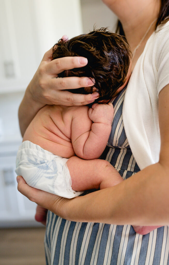 A newborn's back rolls are on display during a Fort Worth newborn session.
