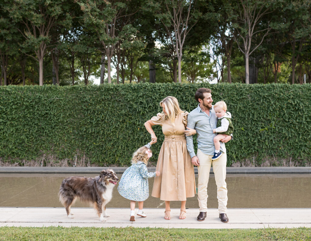 A mom twirls her daughter, and a dad holds their young son, while Allison Krogness captures their Fort Worth fall mini session.
