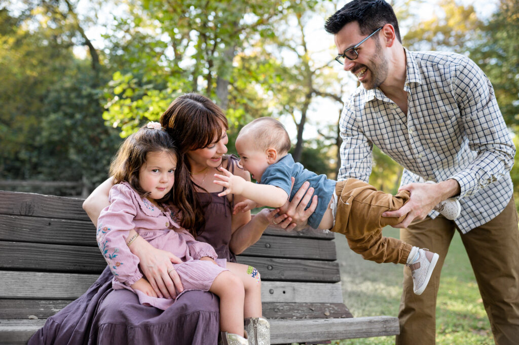 Fort Worth fall mini sessions in a local park while Allison Krogness captures a family family on a park bench.
