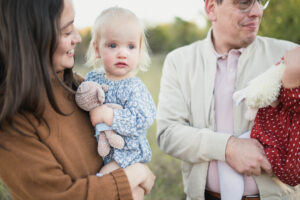 mom holding daughter for family photo with allison krogness