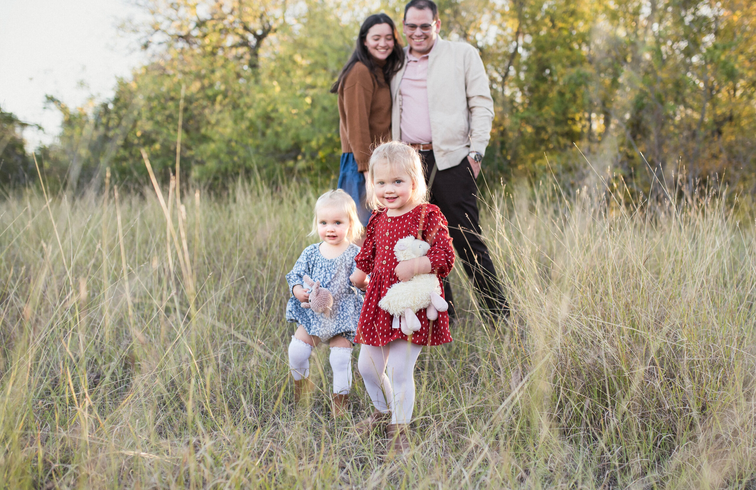 family walking in a field for family mini session