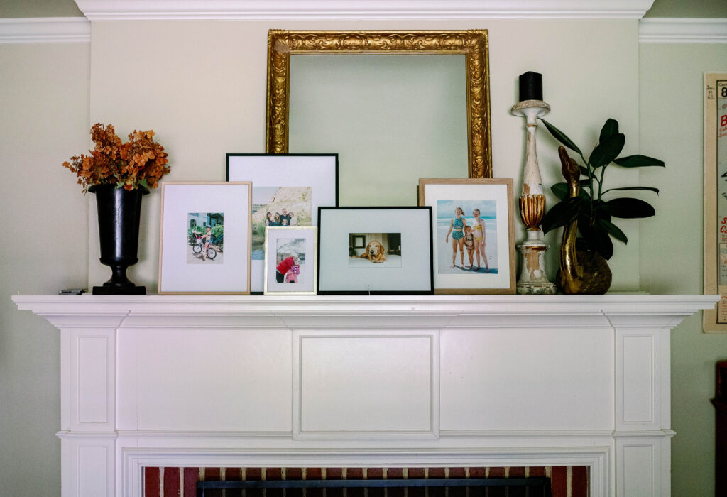 collection of family photographs on mantel
