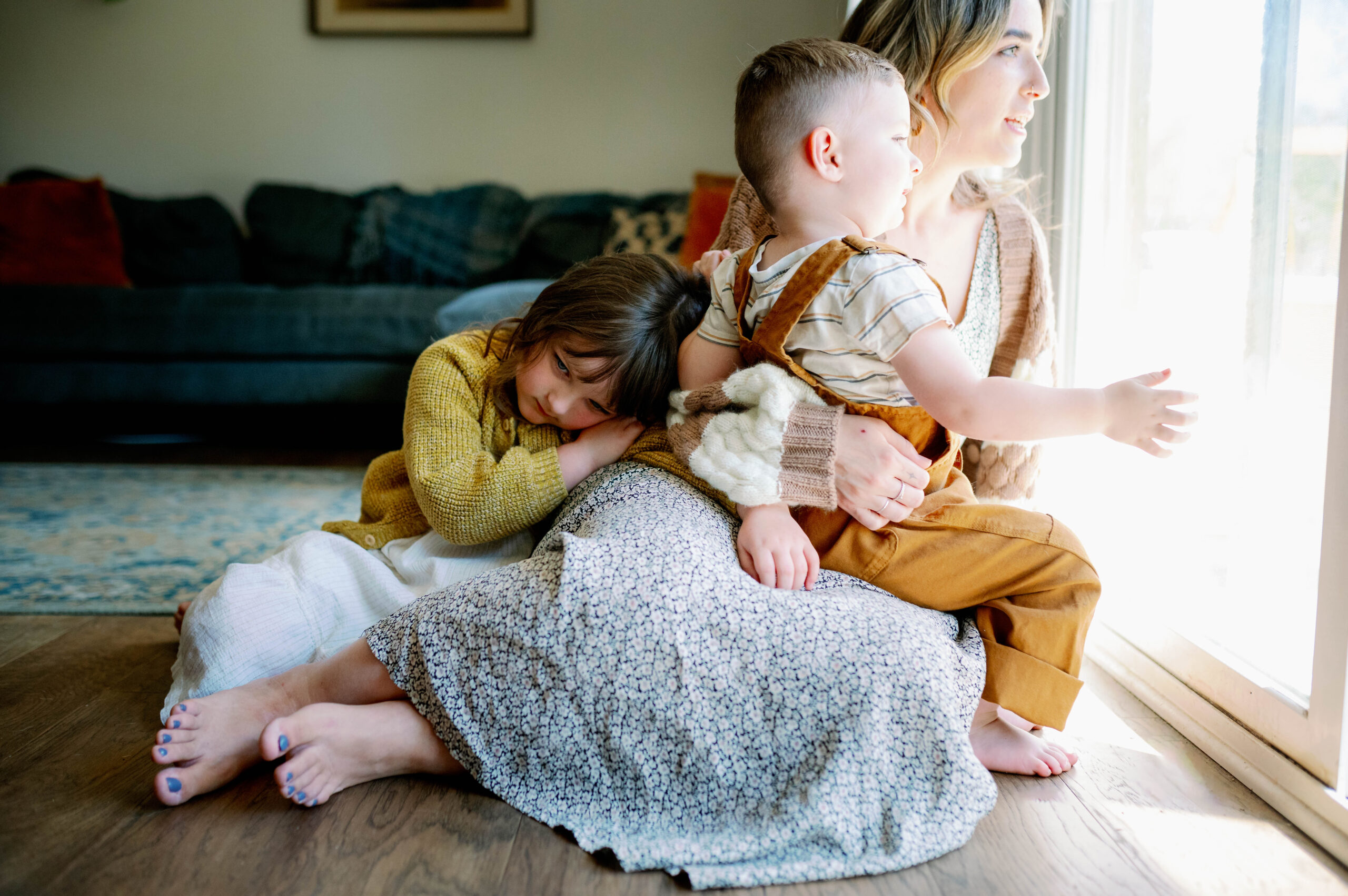 Mom looks out window with kids