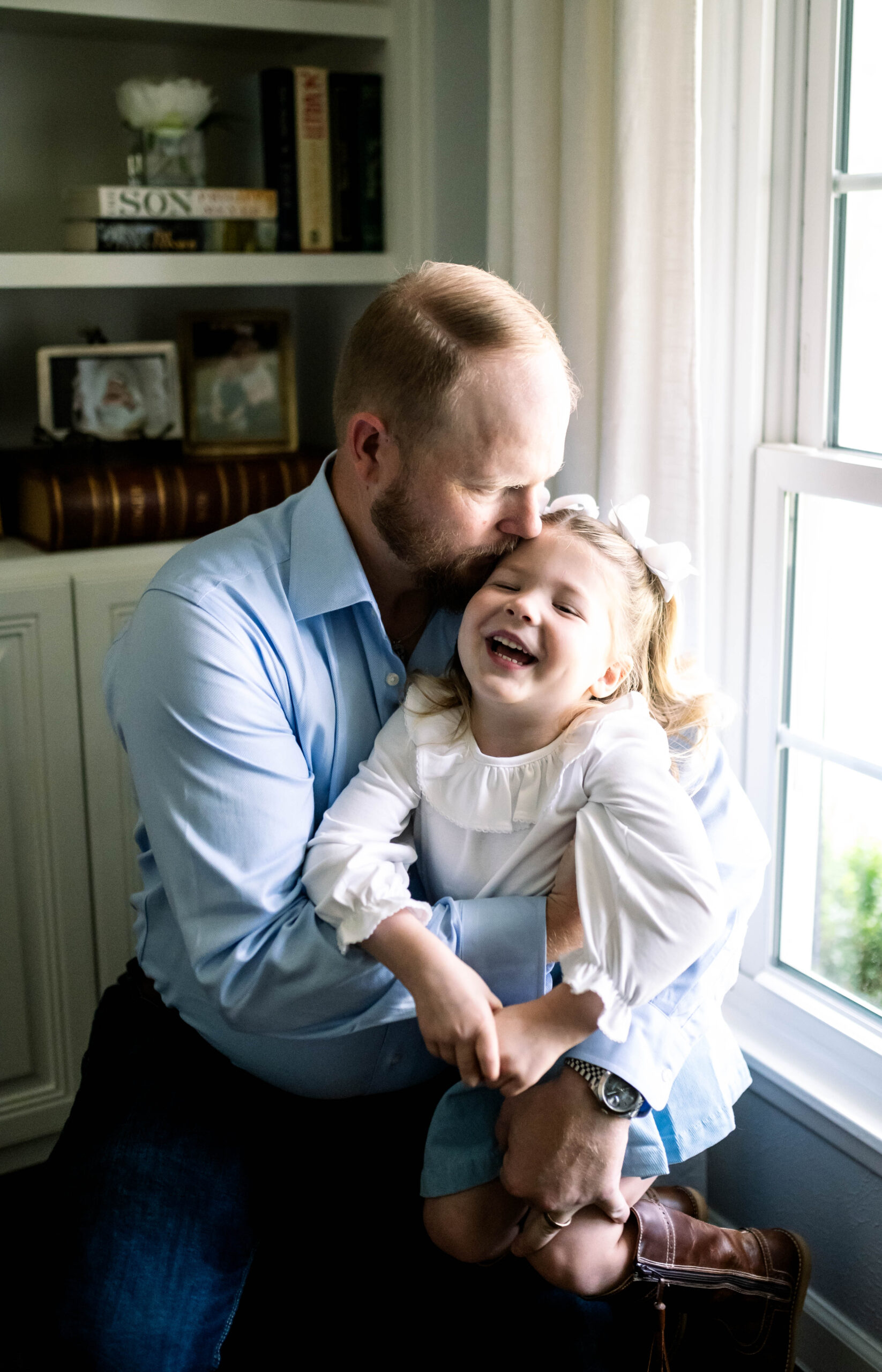 dad holding daughter portrait