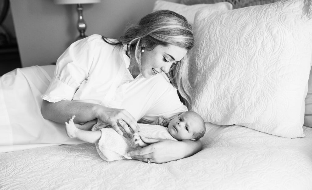 mom cradling newborn for Allison Krogness Photography newborn session