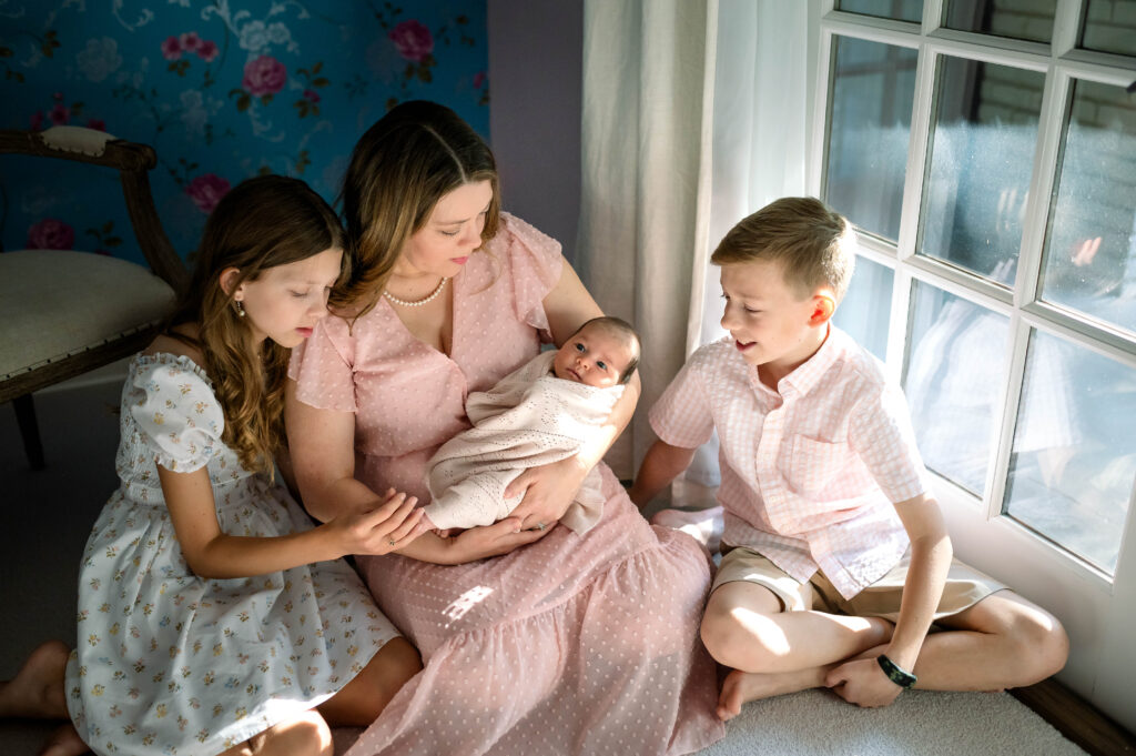 family looking at newborn in fort worth newborn session