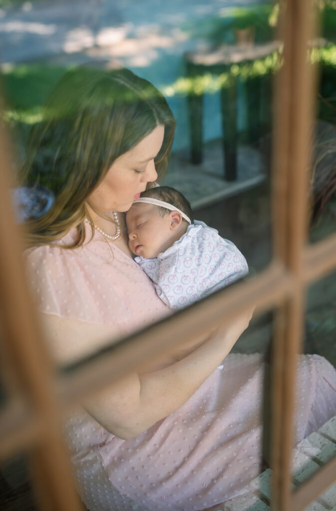 mom cradling newborn baby