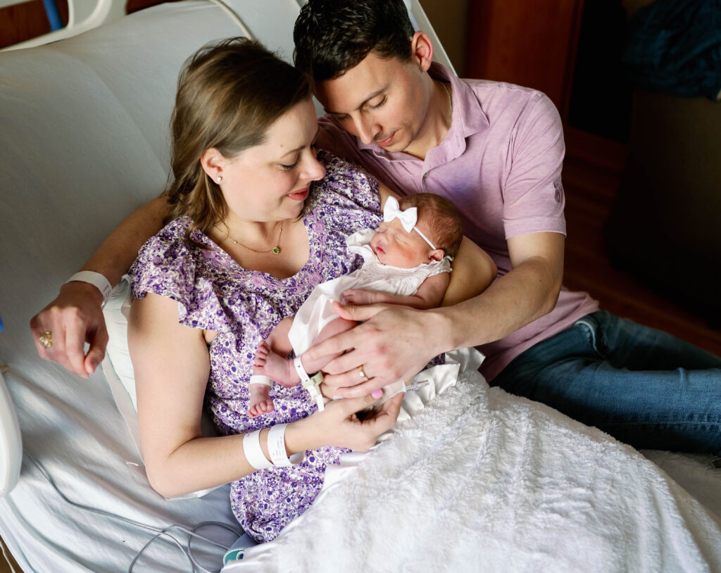mom and dad holding newborn
