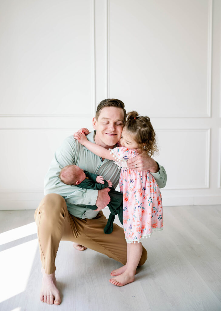 dad- holding- two -children -newborn- session -fort worth