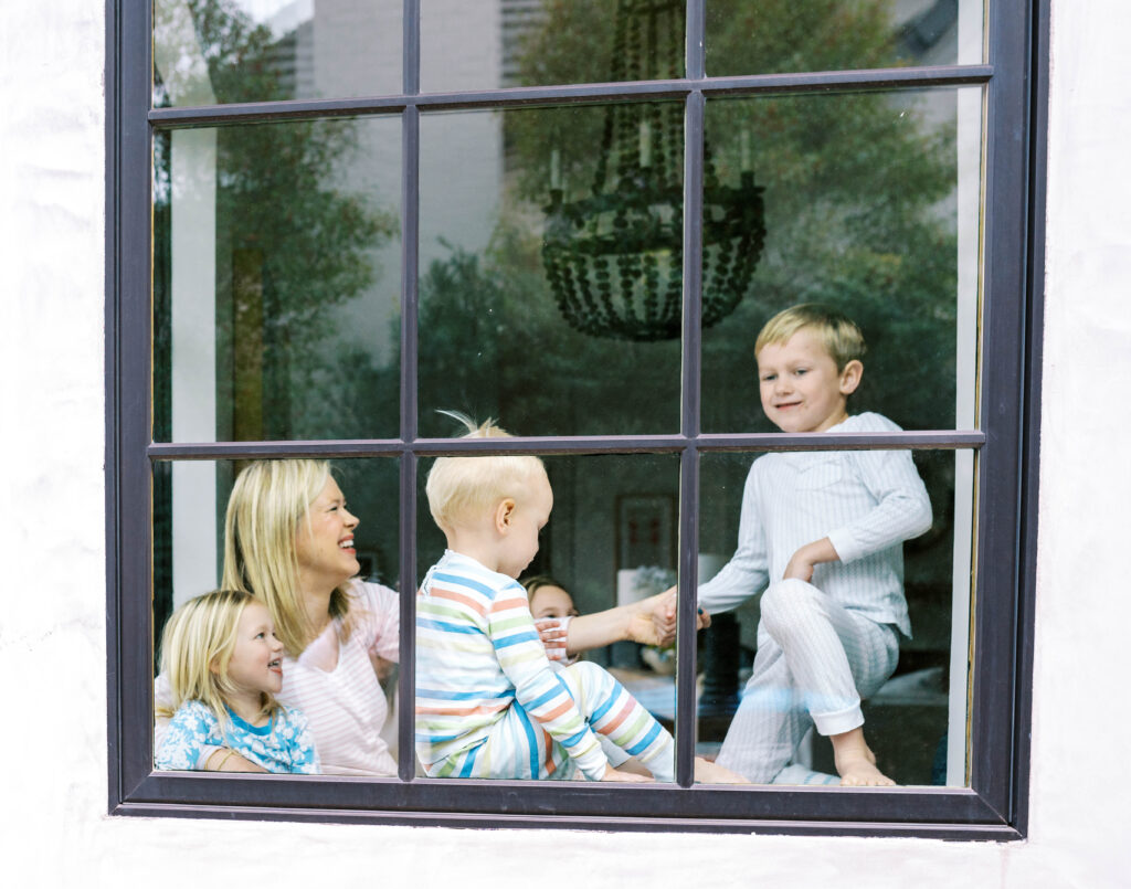 mom and kids playing in the window
